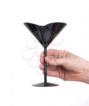 Black plastic coctail glass in hand, isolated on white