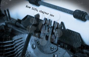 Close-up of an old typewriter with paper, selective focus, New life, chapter one