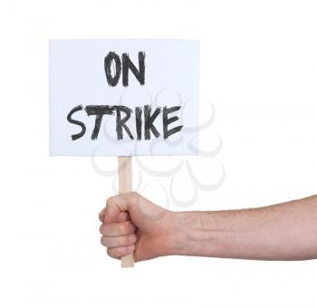 Hand holding sign, isolated on white - On strike