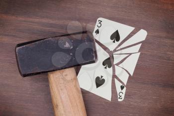 Hammer with a broken card, vintage look, three of spades