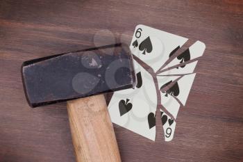 Hammer with a broken card, vintage look, six of spades