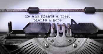 Close-up of a vintage typewriter, old and rusty, he who plants a tree plants a hope