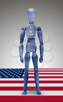 Old wood figure mannequin with US state flag bodypaint - Michigan