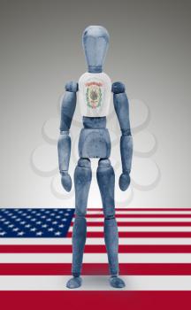 Old wood figure mannequin with US state flag bodypaint - West Virginia