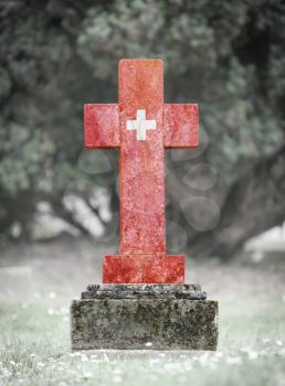 Old weathered gravestone in the cemetery - Switzerland