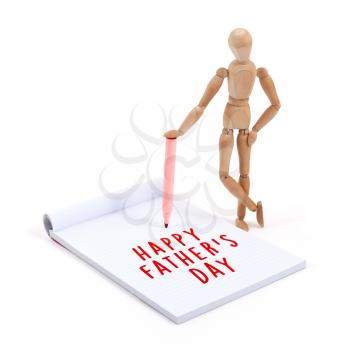 Wooden mannequin writing in a scrapbook - Happy fathers day