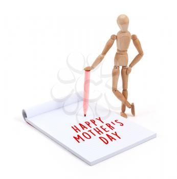 Wooden mannequin writing in a scrapbook - Happy mothers day
