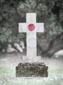 Old weathered gravestone in the cemetery - Japan