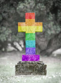 Old weathered gravestone in the cemetery - Rainbow flag