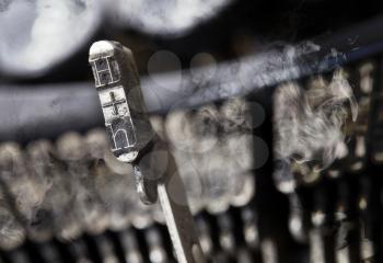 H hammer for writing with an old manual typewriter - mystery smoke