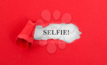 Text appearing behind torn red envelop - Selfie