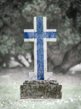 Old weathered gravestone in the cemetery - Finland