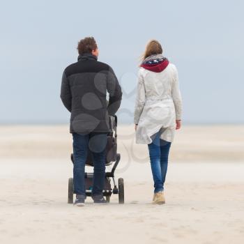 Young couple walking on the beach in the Netherlands