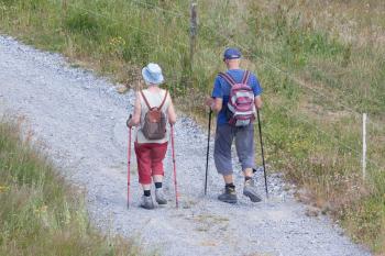 Senior tourist couple hiking at the beautiful mountains, Switzerland