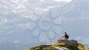 Hiker, young woman with backpack enjoying the scenery, Switzerland