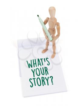 Wooden mannequin writing in a scrapbook - What's your story