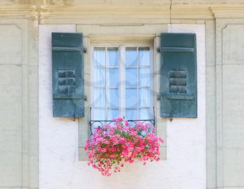 Old window and flowers at a historic building, Bern, Switzerland