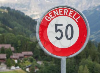 Traffic sign speed limit fifty, village in Switzerland