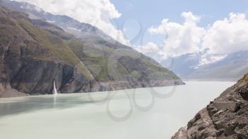 The green waters of Lake Dix - Dam Grand Dixence - Switzerland, worlds tallest gravity dam
