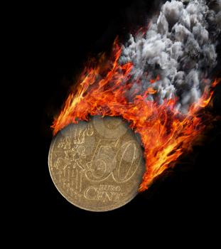 Burning coin with a trail of fire and smoke - 50 eurocent