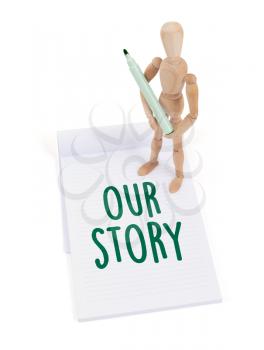 Wooden mannequin writing in a scrapbook - Our story