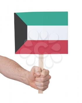 Hand holding small card, isolated on white - Flag of Kuwait