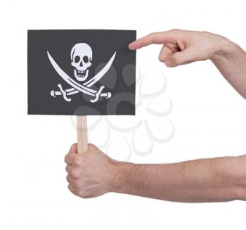 Hand holding small card, isolated on white - Flag of Pirate