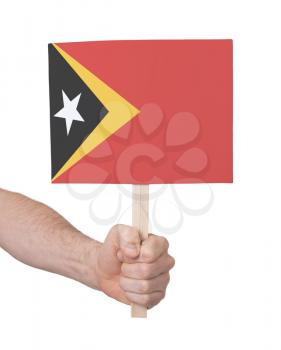 Hand holding small card, isolated on white - Flag of East Timor