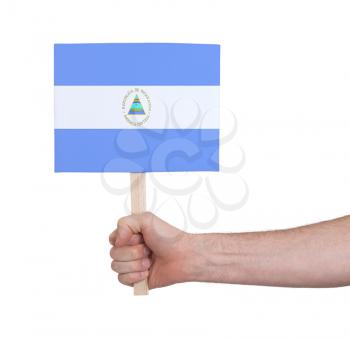 Hand holding small card, isolated on white - Flag of Nicaragua