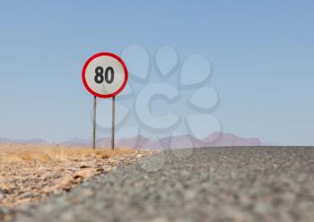 Speed limit sign at a desert road in Namibia, speed limit of 80 kph or mph