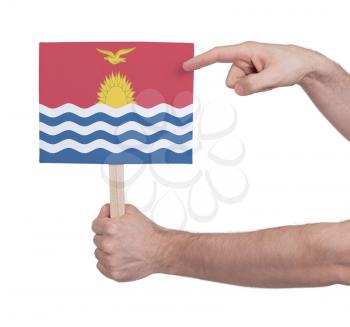 Hand holding small card, isolated on white - Flag of Kiribati