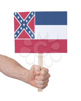 Hand holding small card, isolated on white - Flag of Mississippi