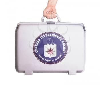Used plastic suitcase with stains and scratches, printed with flag - CIA