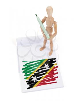 Wooden mannequin made a drawing of a flag - Saint Kitts and Nevis