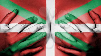 Upper part of female body, hands covering breasts, flag of Basque Country