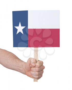 Hand holding small card, isolated on white - Flag of Texas