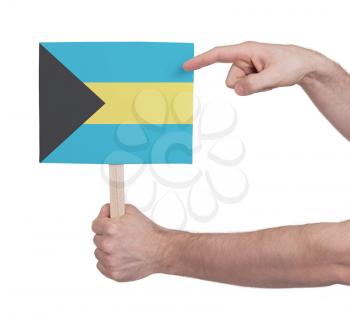 Hand holding small card, isolated on white - Flag of Bahamas