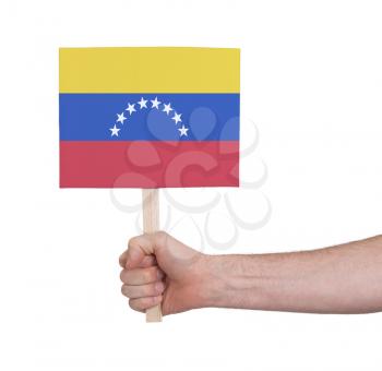 Hand holding small card, isolated on white - Flag of Venezuela