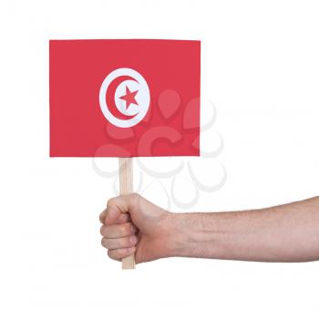 Hand holding small card, isolated on white - Flag of Tunisia