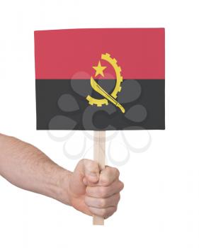 Hand holding small card, isolated on white - Flag of Angola