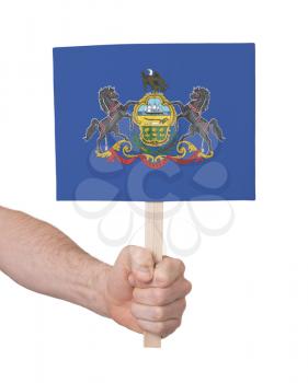 Hand holding small card, isolated on white - Flag of Pennsylvania