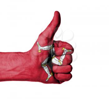 Closeup of male hand showing thumbs up sign, flag of Isle of Man