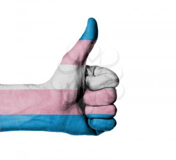 Closeup of male hand showing thumbs up sign, flag of Trans Pride