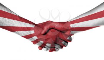 Man and woman shaking hands, wrapped in flag pattern, Japan