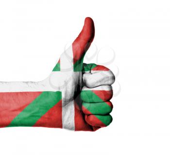 Closeup of male hand showing thumbs up sign, flag of Basque Country