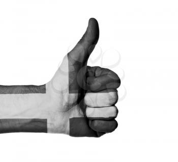 Closeup of male hand showing thumbs up sign, flag of Cornwall