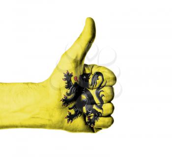 Closeup of male hand showing thumbs up sign, flag of Flanders