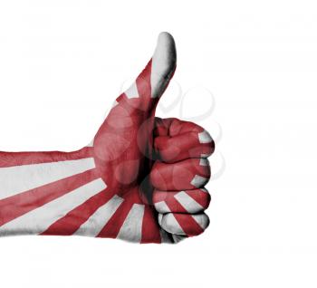 Closeup of male hand showing thumbs up sign, flag of Japan