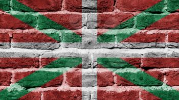 Very old dark red brick wall texture, flag of Basque Country