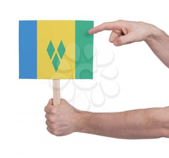 Hand holding small card, isolated on white - Flag of Saint Vincent and the Grenadines
